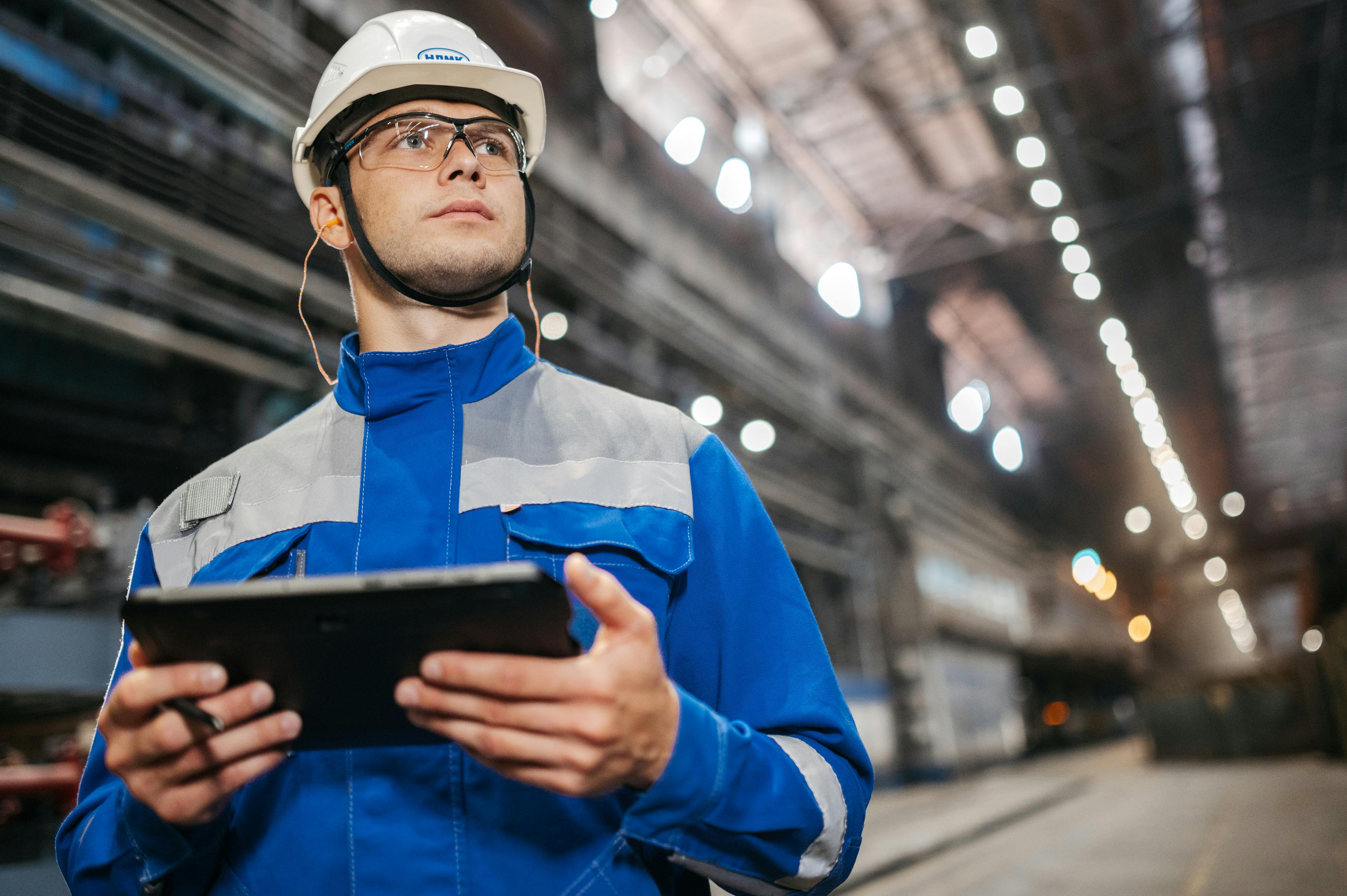 Site inspector reviewing a tablet on the floor